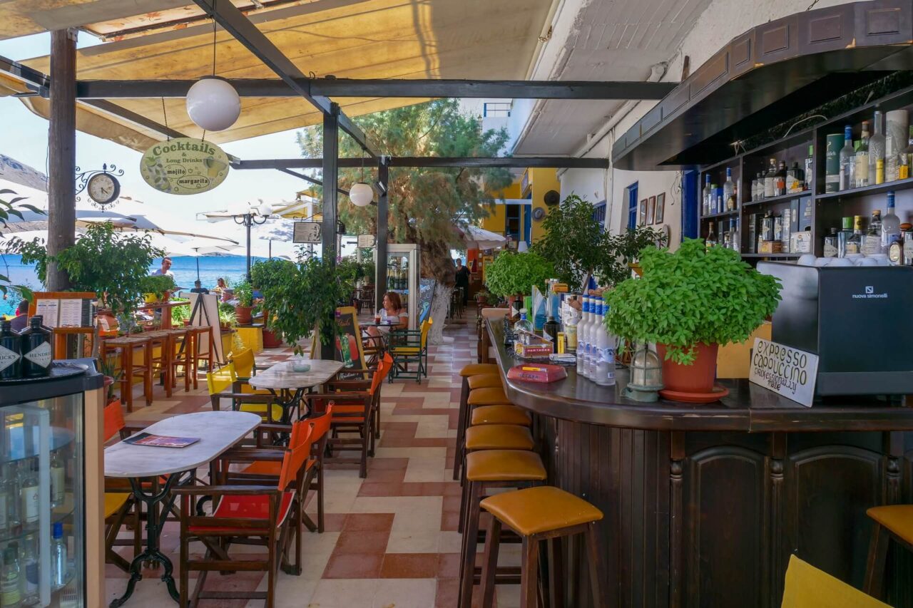 coffee-shop-waterfront-loutro-fishing-village-arriving-by-boat-trip-from-mistral-hotel-for-solo-travellers-in-crete-greece